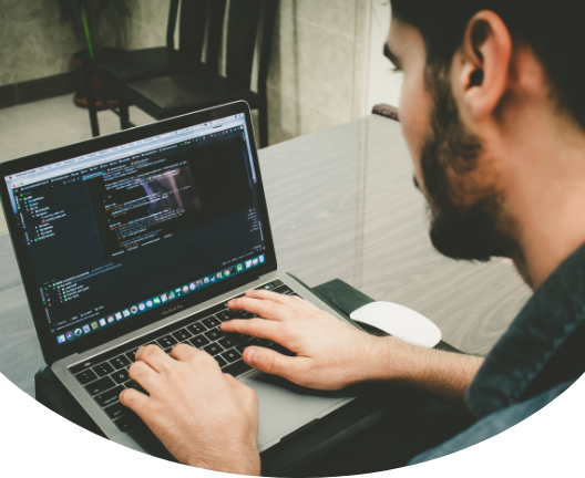 男の人がプログラミングコードを書いている写真